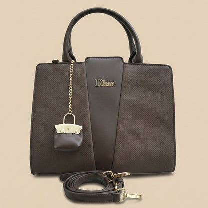 Brown handbag with matching pouch and detachable strap on a beige background