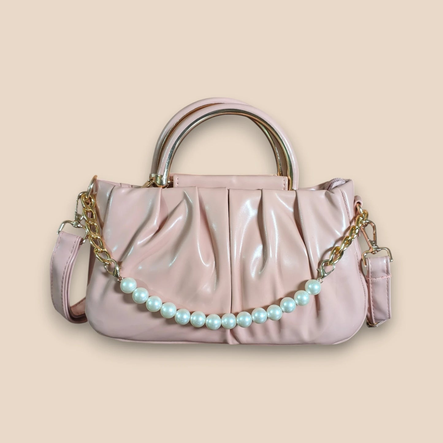 Pink handbag with a pearl chain on a beige background