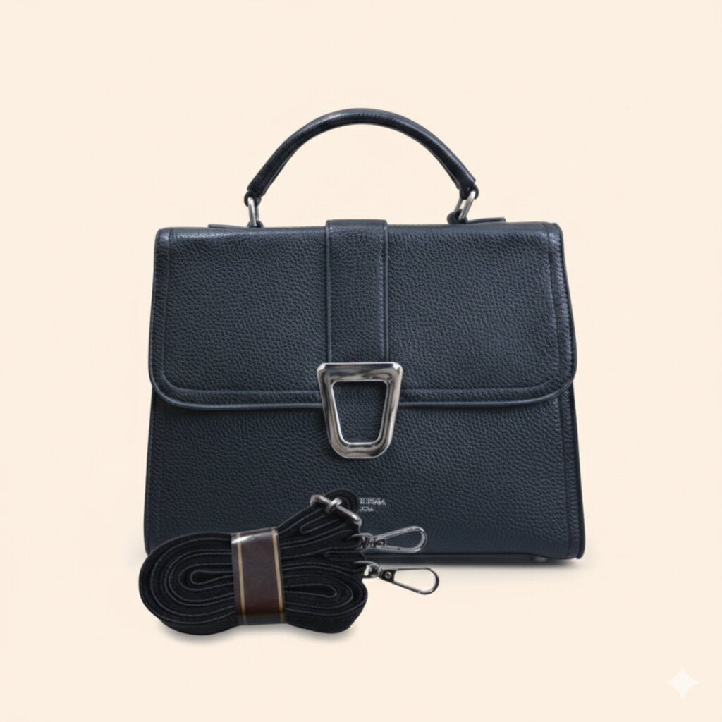 Black leather handbag with a strap on a beige background
