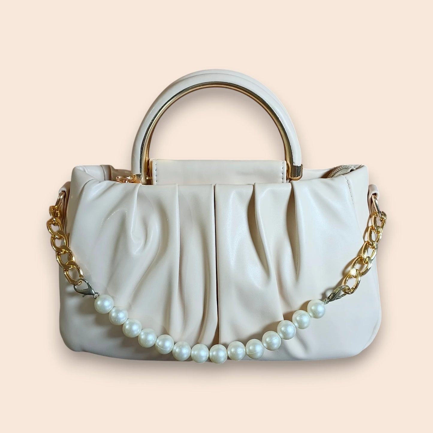 Off White handbag with gold chain and pearl details on a beige background